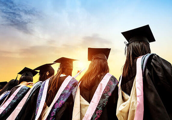 back view of graduates looking at the sunset